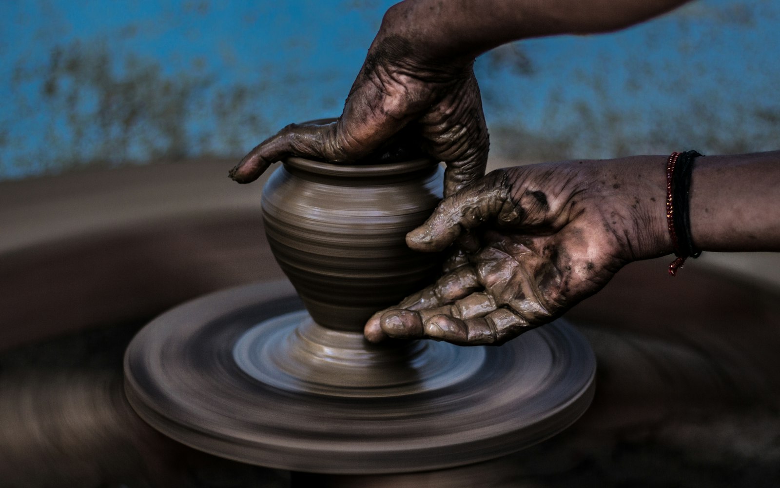 Shaping clay on the pottery wheel